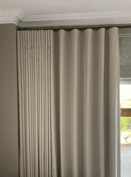 Luxurious wave header curtains in a beautifully dressed room